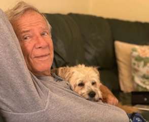 Bernhard Winkler at home with his dog